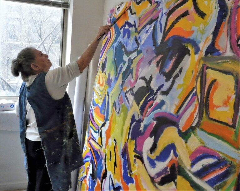 Dorothy Krakovsky painting a large canvas