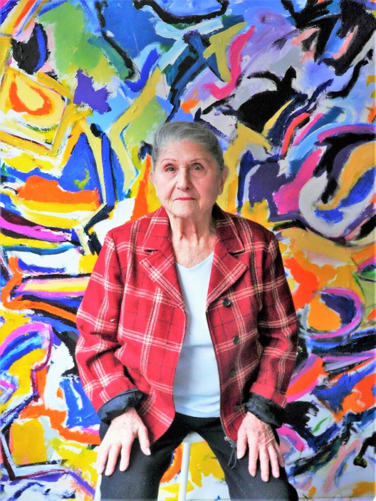 Dorothy Krakovsky sat with painting Minnesota Lake District